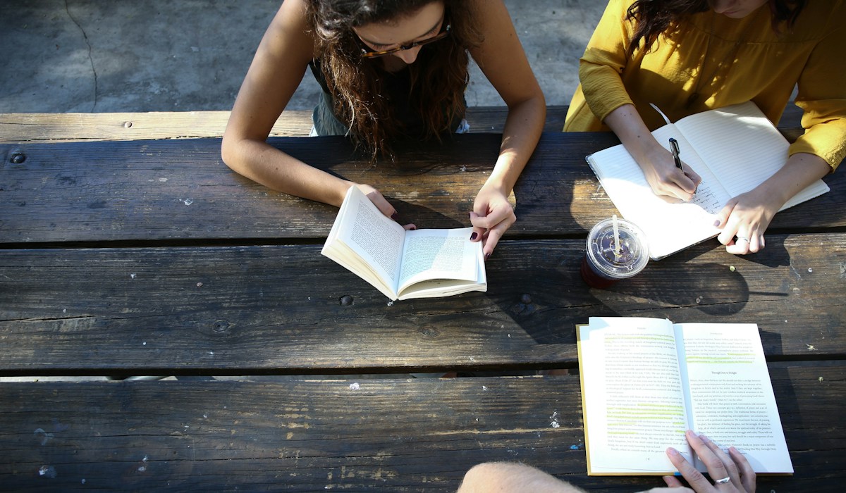 Woman reading a book while sitting on a chair