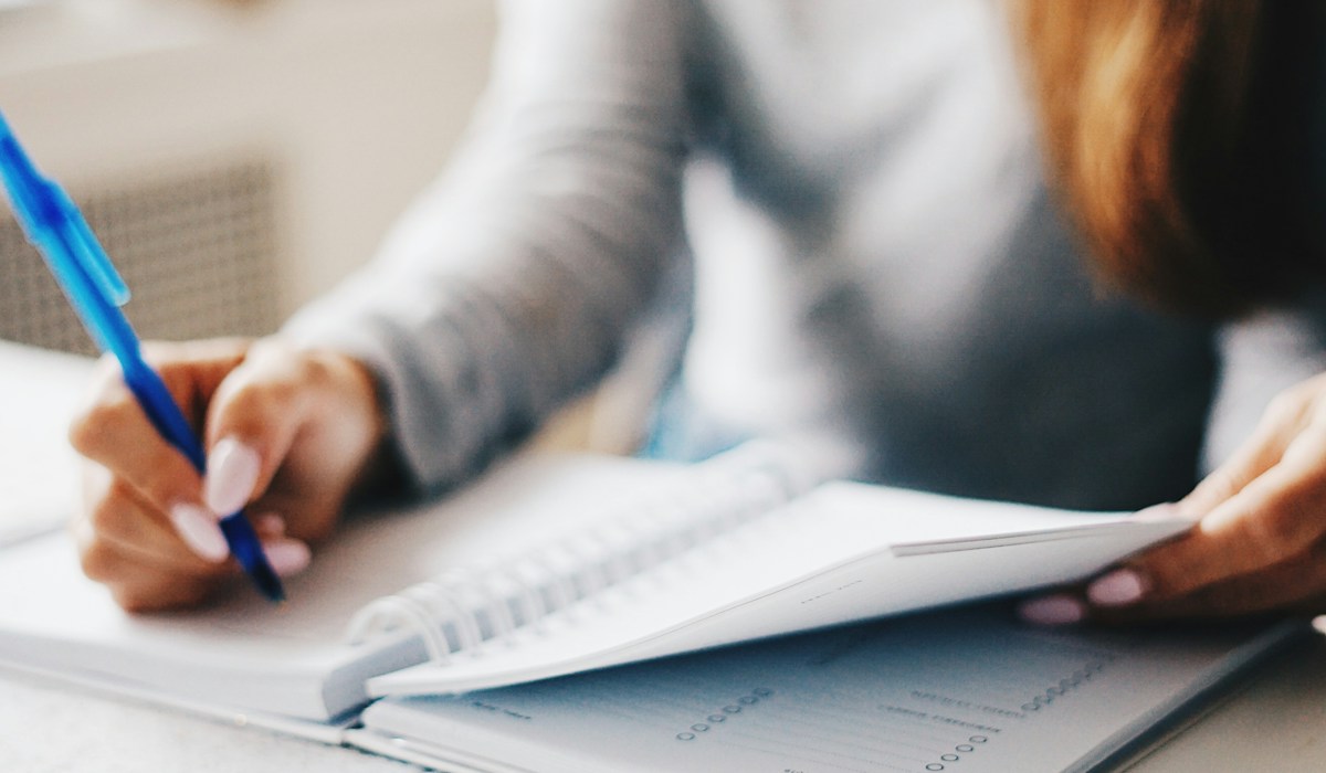 Woman writing using a pen