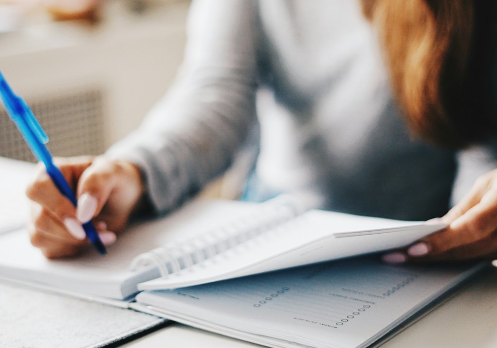 Woman writing using a pen
